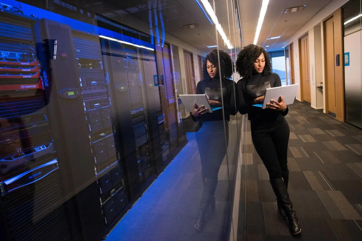 A woman working in a server room.