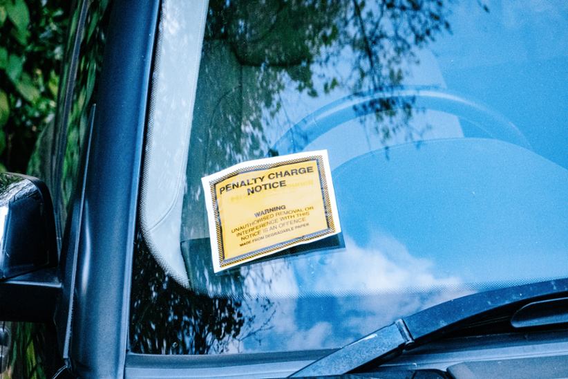 penalty-charge-notice-taped-to-a-windshield-of-a-car