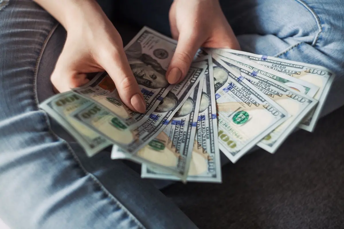 woman-holding-100-us-dollar-bills