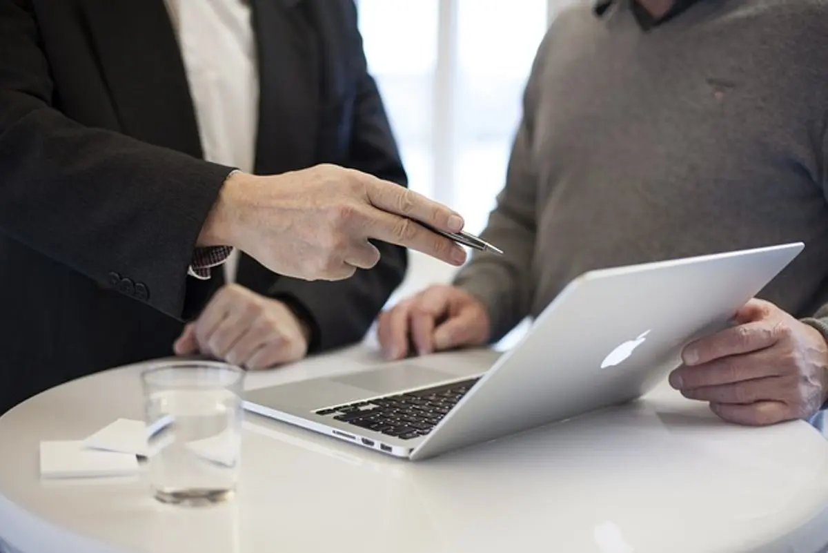 businessmen-discussing-a-topic-in-front-of-laptop