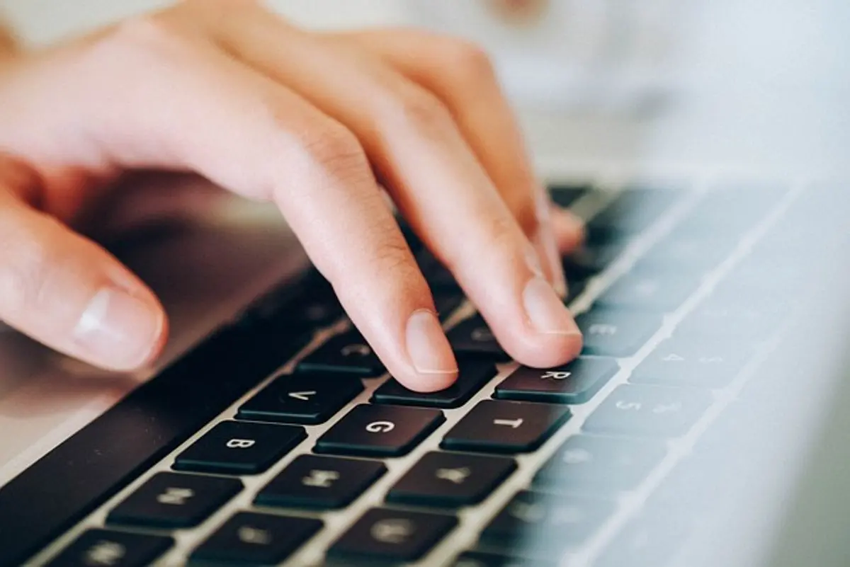 a-hand-on-top-of-computer-keyboard