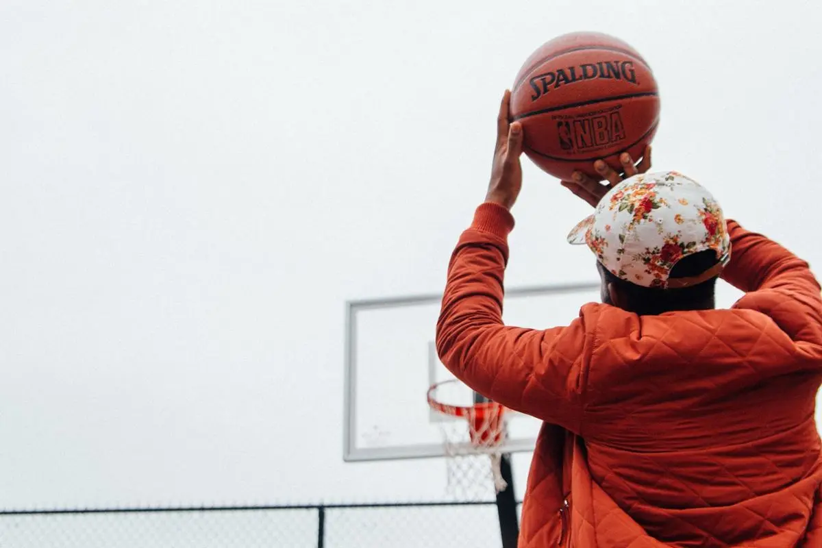 A man shooting a basketball.