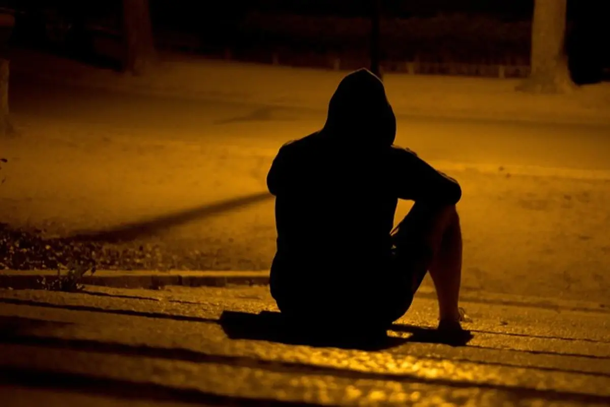 man-sitting-alone-in-a-dark-park