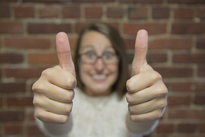 woman-holding-thumbs-up-gesture