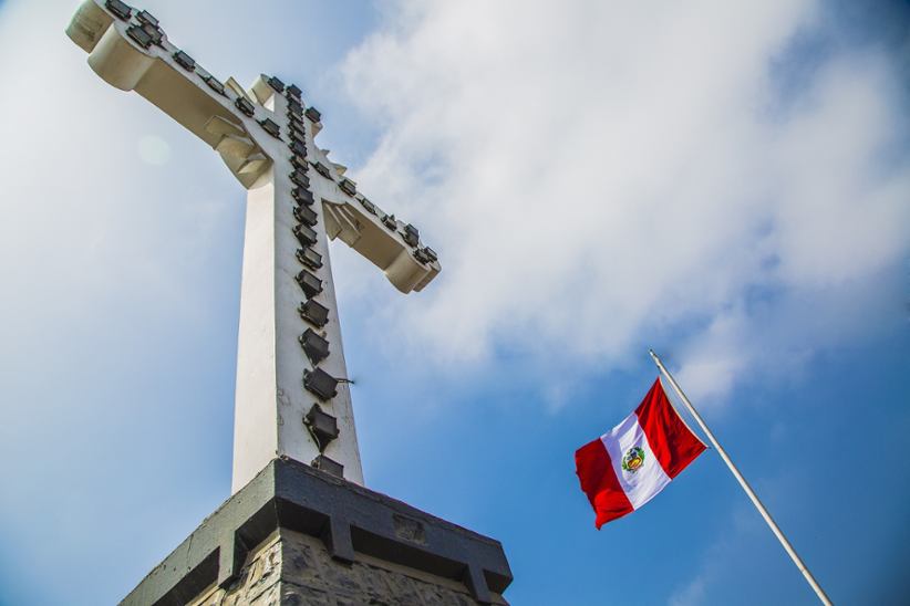 Peru's national flag outside a temple or a church.