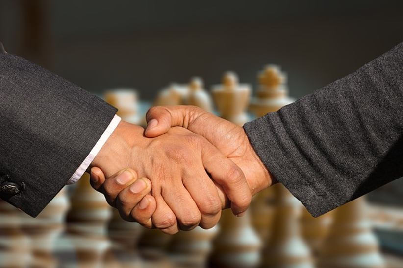 handshake-chess-board-in-background
