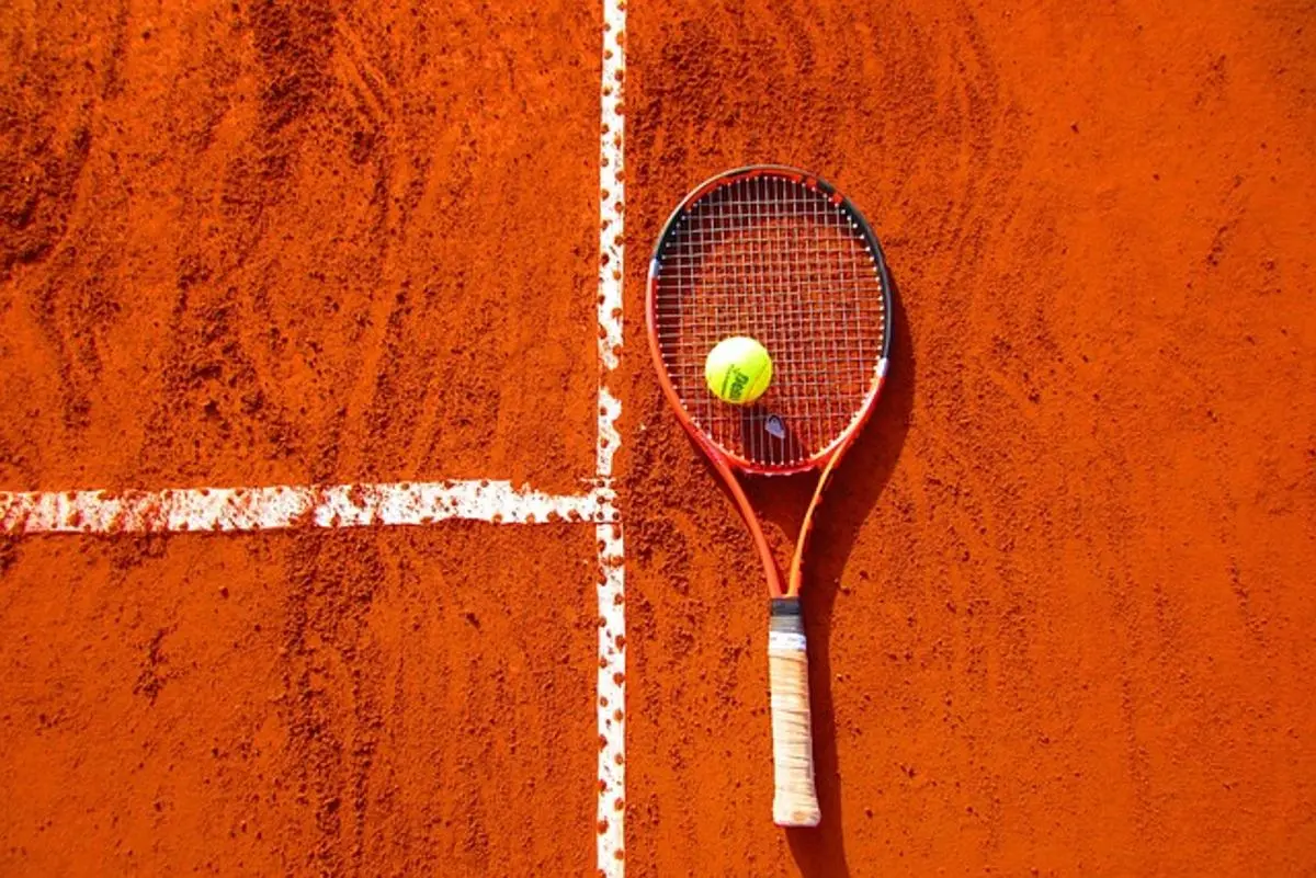 tennis-racket-and-ball-on-a-court