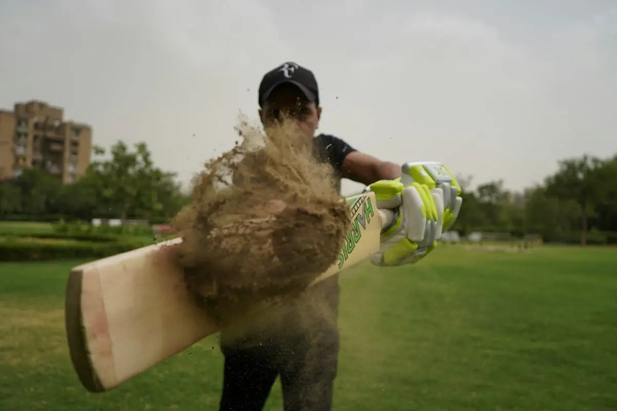 A cricket player batting away